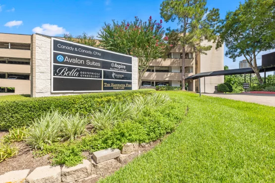 Office building tenant directory sign with landscaped garden