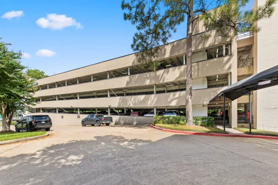 Multi-level parking garage exterior with cars